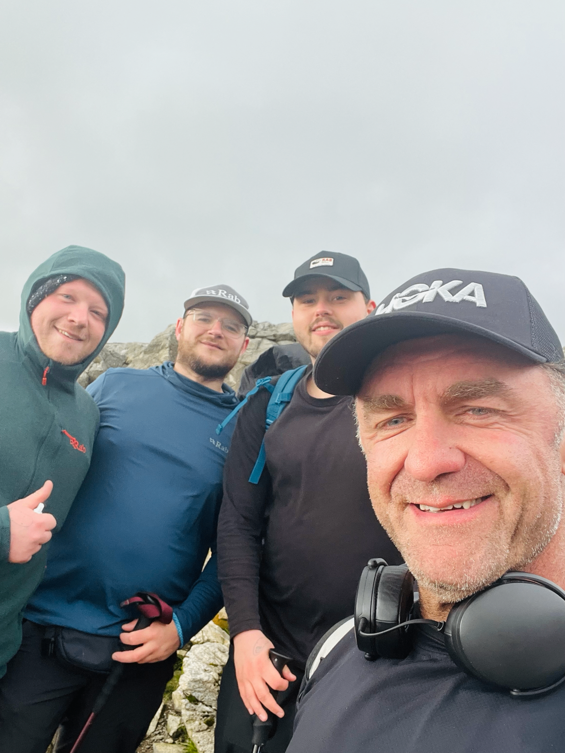 Rob and a Sidekick Initiative group at a summit in the hills.